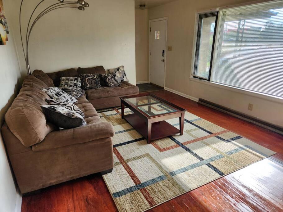 a living room with a couch and a coffee table at Spacious 4-bedroom home in quiet neighborhood in Milwaukee