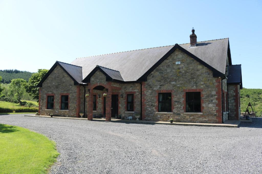 a stone house with a gravel driveway at Loughcrew View Bed and Breakfast in Kells