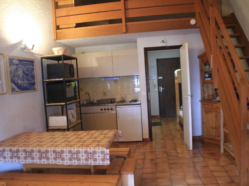 a kitchen with a staircase leading into a room at Appartement Châtel, 2 pièces, 6 personnes - FR-1-200-211 in Châtel