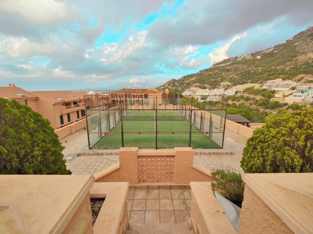a tennis court in the middle of a building at Luxury Apartments Mascarat in Altea