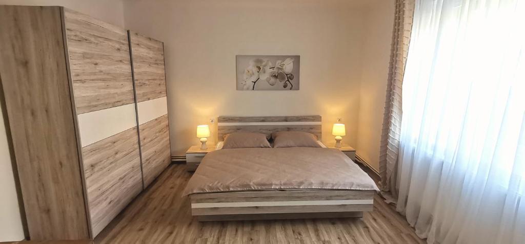a bedroom with a large bed and two lamps at Apartmán 551 in Litomyšl