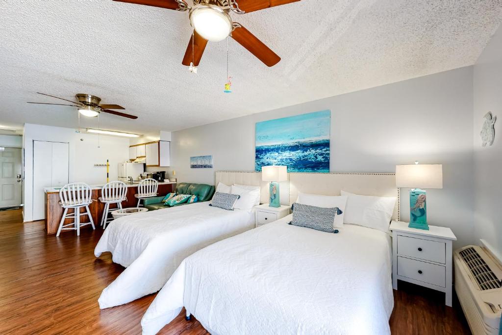 a bedroom with two beds and a living room at Seaward Villas 301 in Ocean City