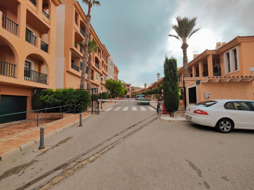 a white car parked on the side of a street at Luxury Apartments Mascarat in Altea