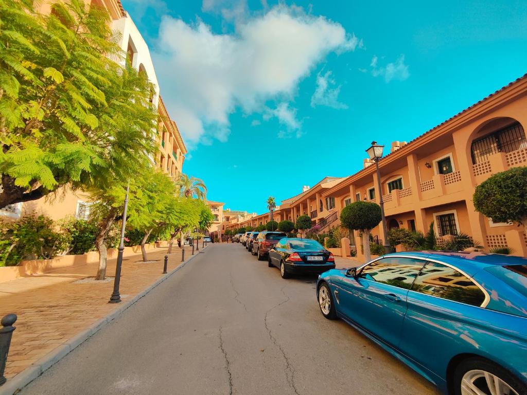 a blue car parked on the side of a street at Luxury Apartments Mascarat in Altea