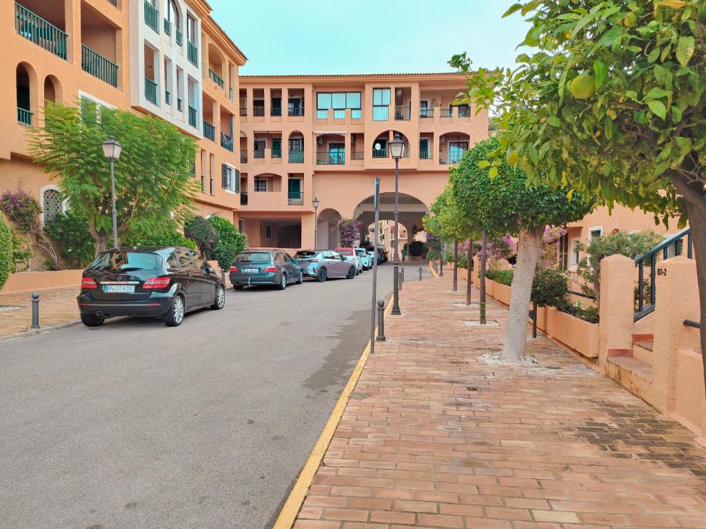 a street with cars parked in front of a building at Luxury Apartments Mascarat in Altea