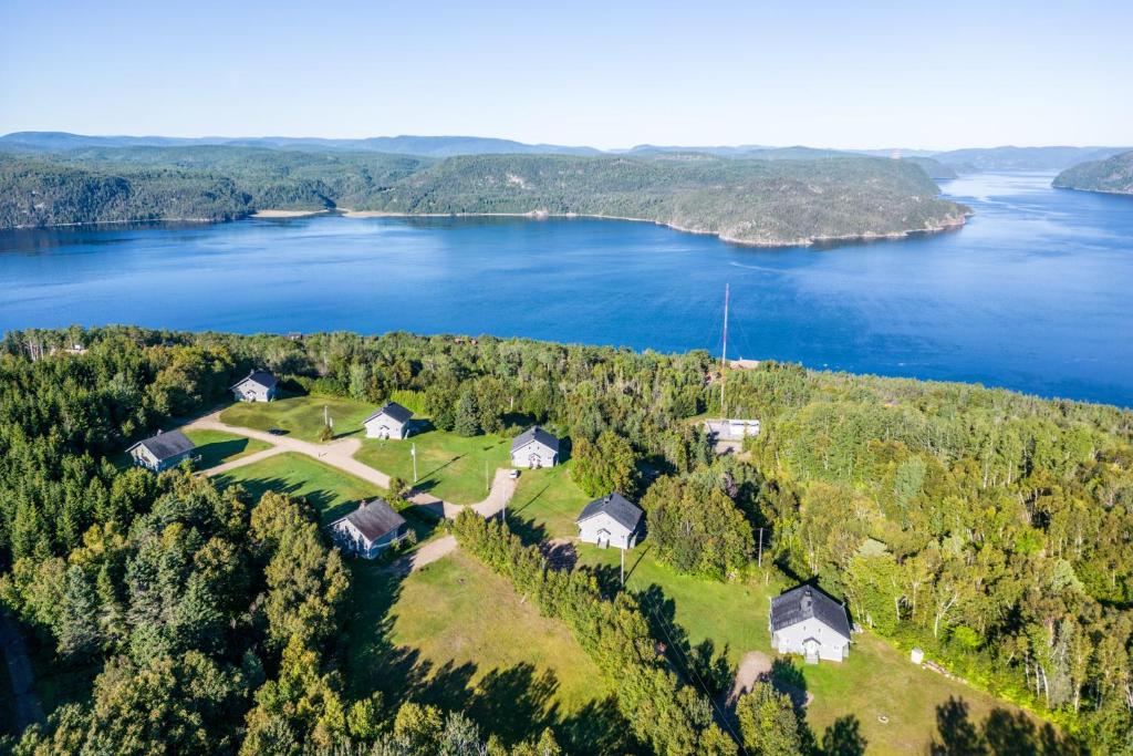 an aerial view of a house on a hill next to a lake at MontFJORD - Chalets, SPA et vue - ChantaFJORD #1 in Sacré-Coeur-Saguenay