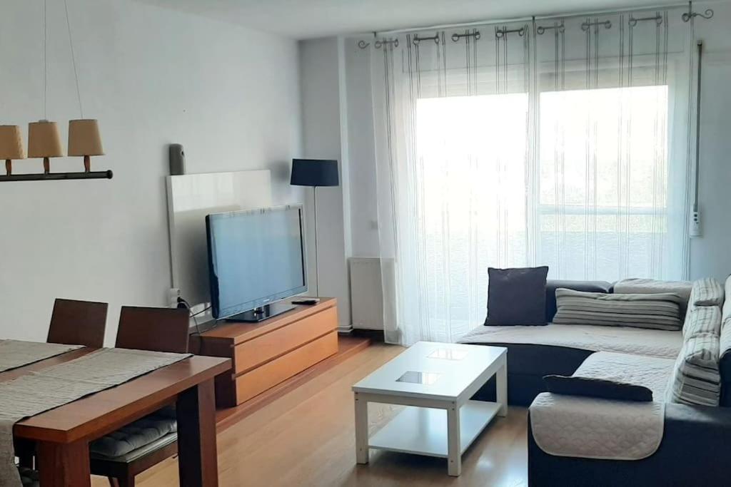 a living room with a couch and a flat screen tv at Precioso Piso Barcelona in Santa Coloma de Cervelló