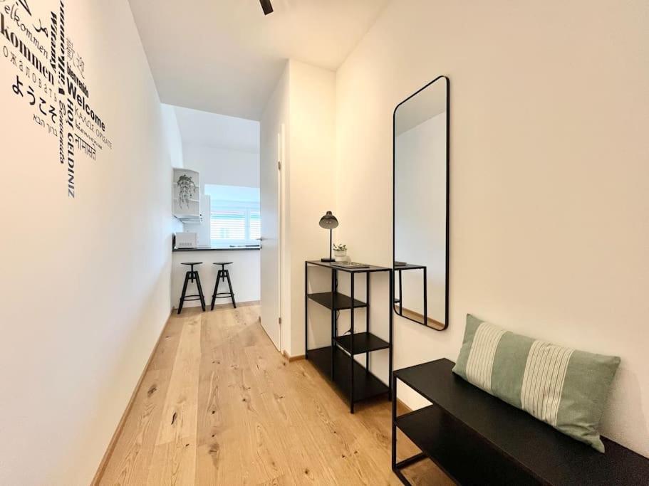 a living room with a table and a mirror at OrestaLiving - Penthouse in 1020 in Vienna