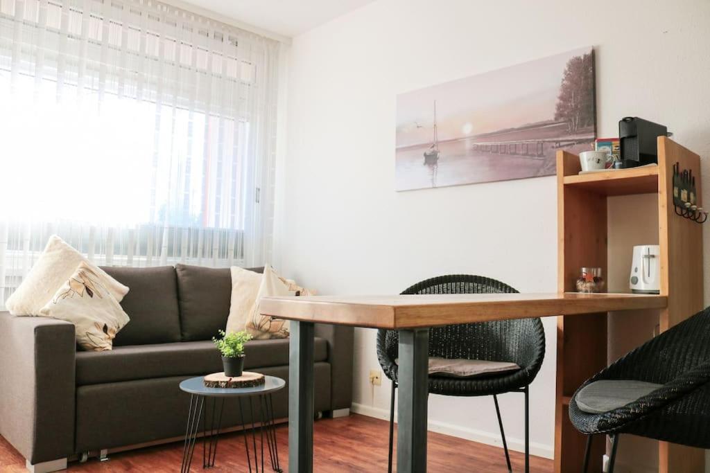a living room with a couch and a table at Apartement Nathalie - Wellness mit Pool und Sauna in Schluchsee
