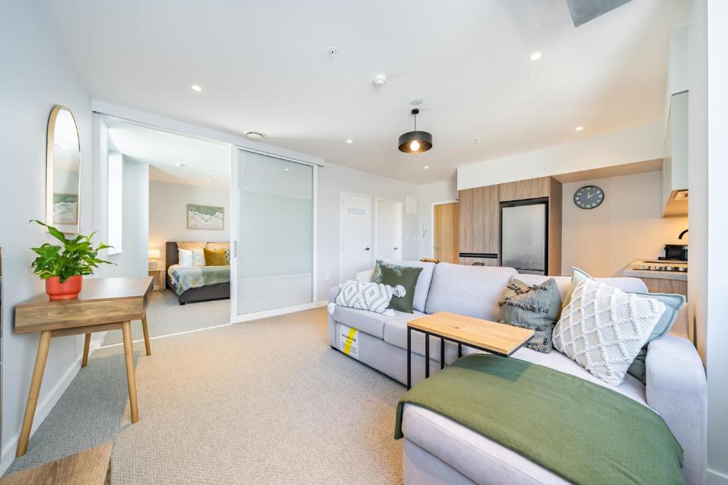 a living room with a couch and a table at Hutt Central in Lower Hutt