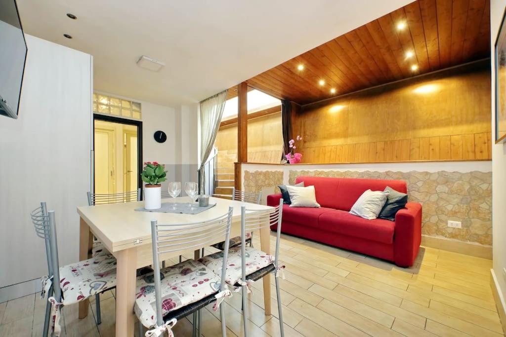 a living room with a red couch and a table at Vatican Flat Spacious Cozy with Court in Rome