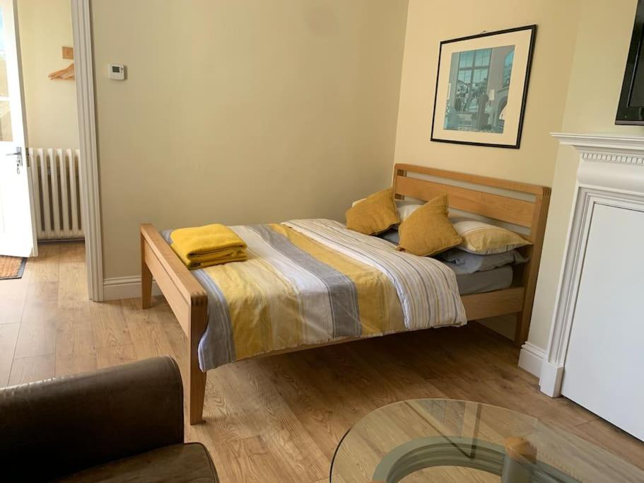 a small bedroom with a bed and a glass table at Walkers Rest! in Alfriston