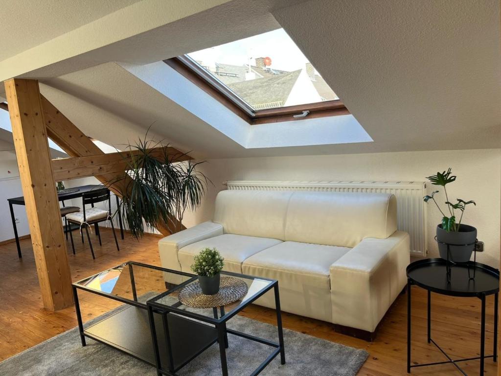 a living room with a white couch and a skylight at Urlaub nicht nur für Monteure "K3" in Gera