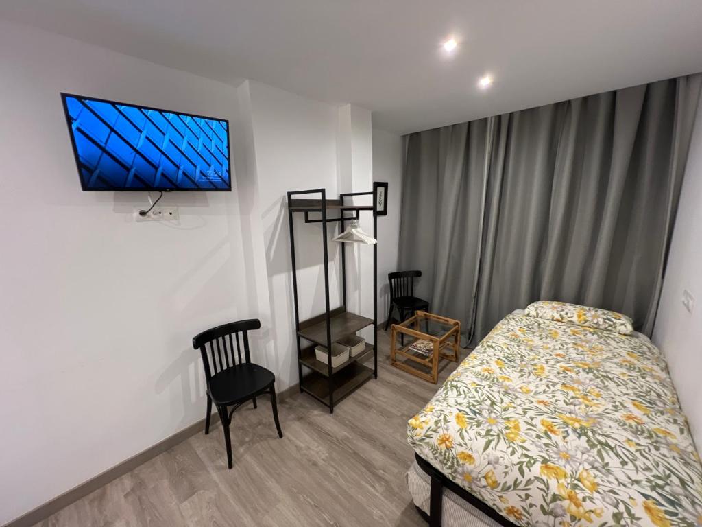 A bed or beds in a room at Nuestro Rinconcito del Soho