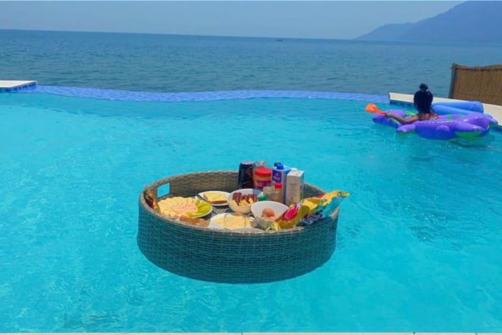 a basket of food in the water in a pool at Escapes in Cape Maclear