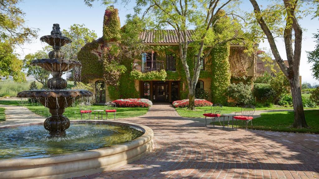 a fountain in front of a house at Vintners Resort in Santa Rosa