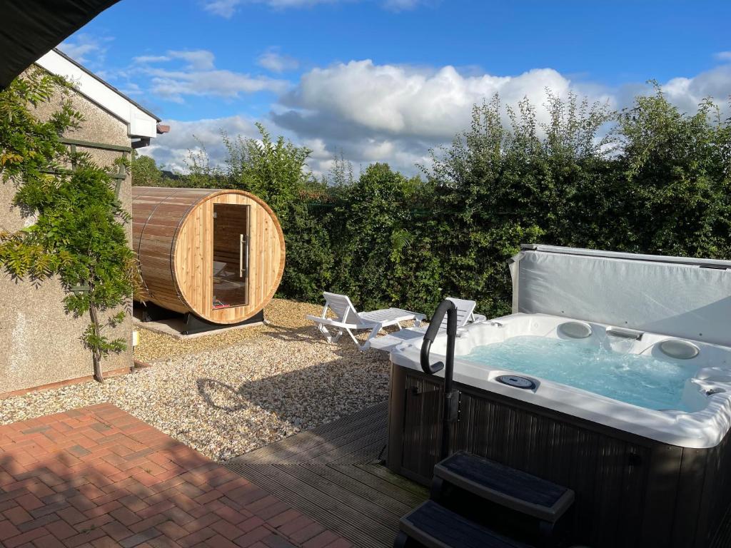 a hot tub in the backyard of a house at Blackthorn Meadow in Pontypool