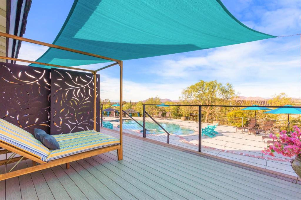 a porch with a hammock and a swimming pool at Villa Inn- Adults Only- Temecula Wine Country in Temecula