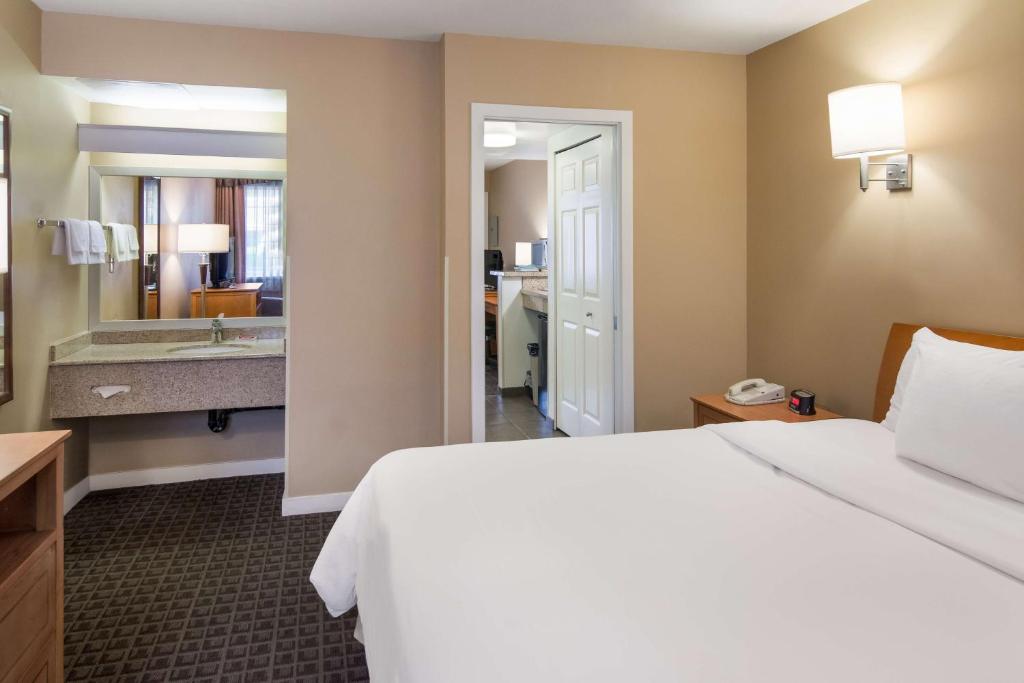 a hotel room with a bed and a bathroom at SureStay Hotel by Best Western North Vancouver Capilano in North Vancouver