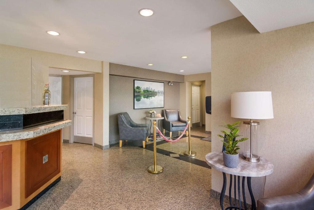 a hotel lobby with chairs and a table and a lamp at SureStay Hotel by Best Western North Vancouver Capilano in North Vancouver