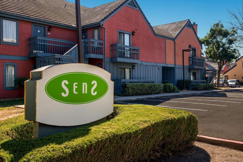 a sap sign in front of a row of houses at SenS Suites Livermore; SureStay Collection by Best Western in Livermore