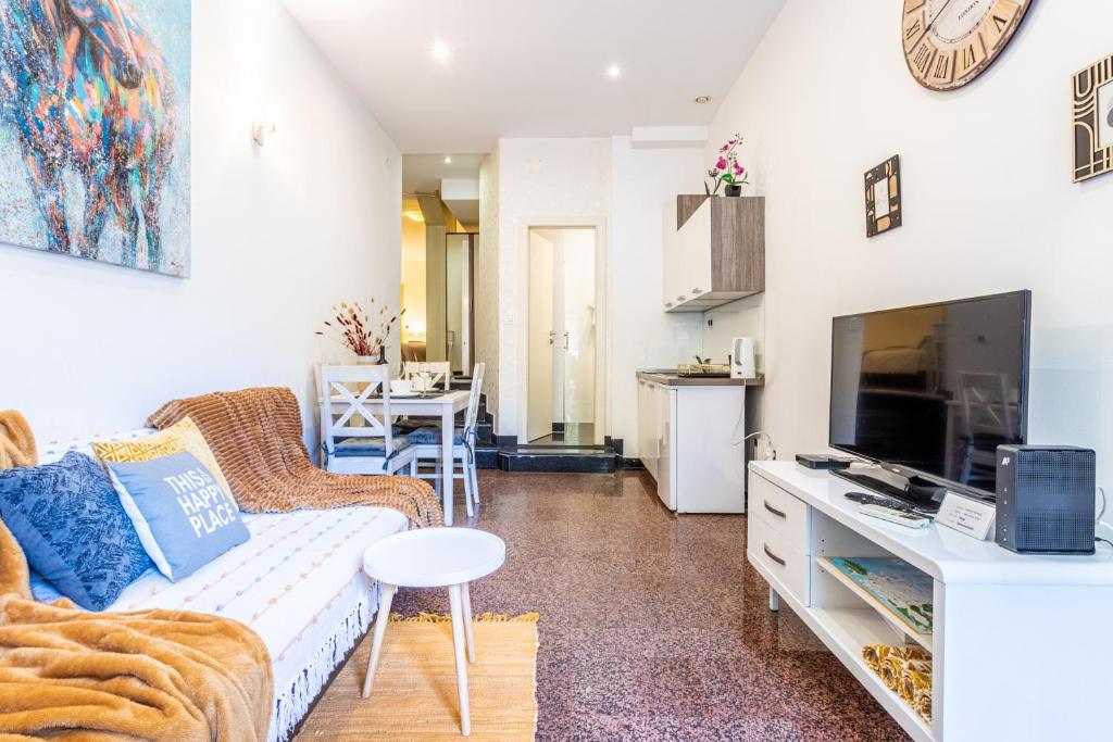 a living room with a couch and a tv at Studio apartment Negi in Split