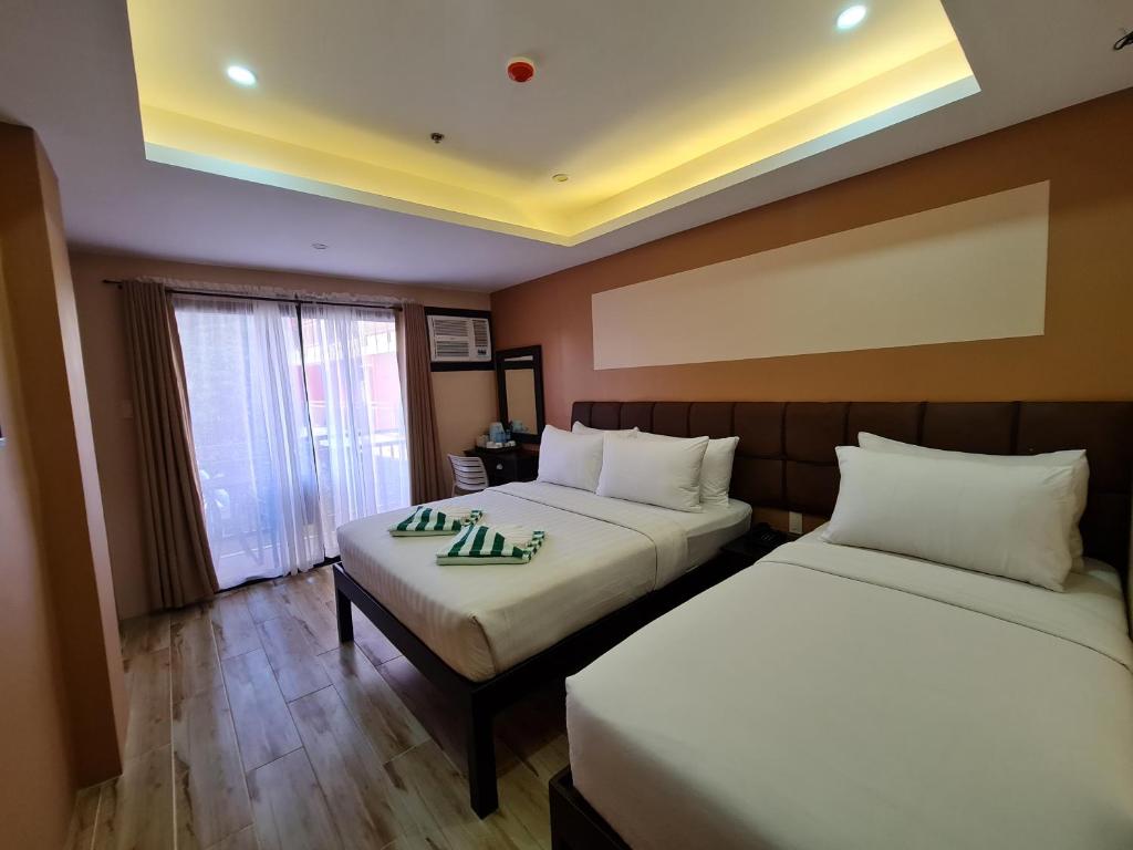 Postel nebo postele na pokoji v ubytování Red Coco Inn de Boracay