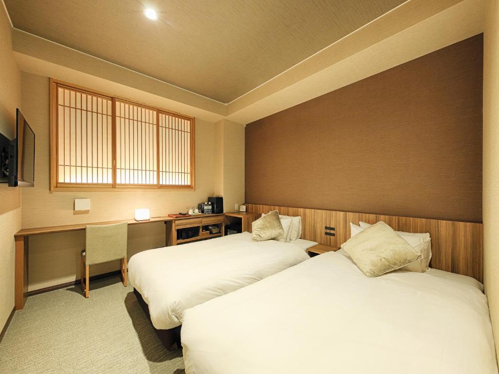 Postel nebo postele na pokoji v ubytování HOTEL CUORE Kyoto Shijo Omiya