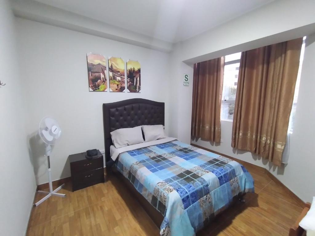 1 dormitorio con 1 cama en una habitación con ventana en Hostal Pacífico Huánuco, en Huánuco