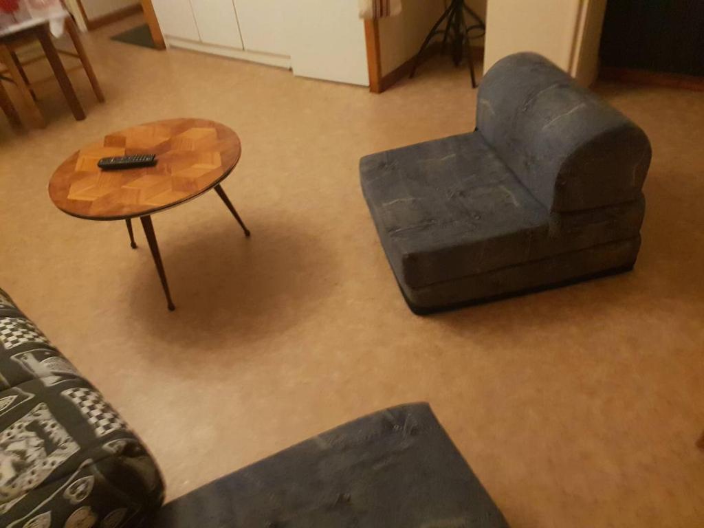 a living room with a chair and a coffee table at Appartement Cauterets, 2 pièces, 4 personnes - FR-1-234-299 in Cauterets