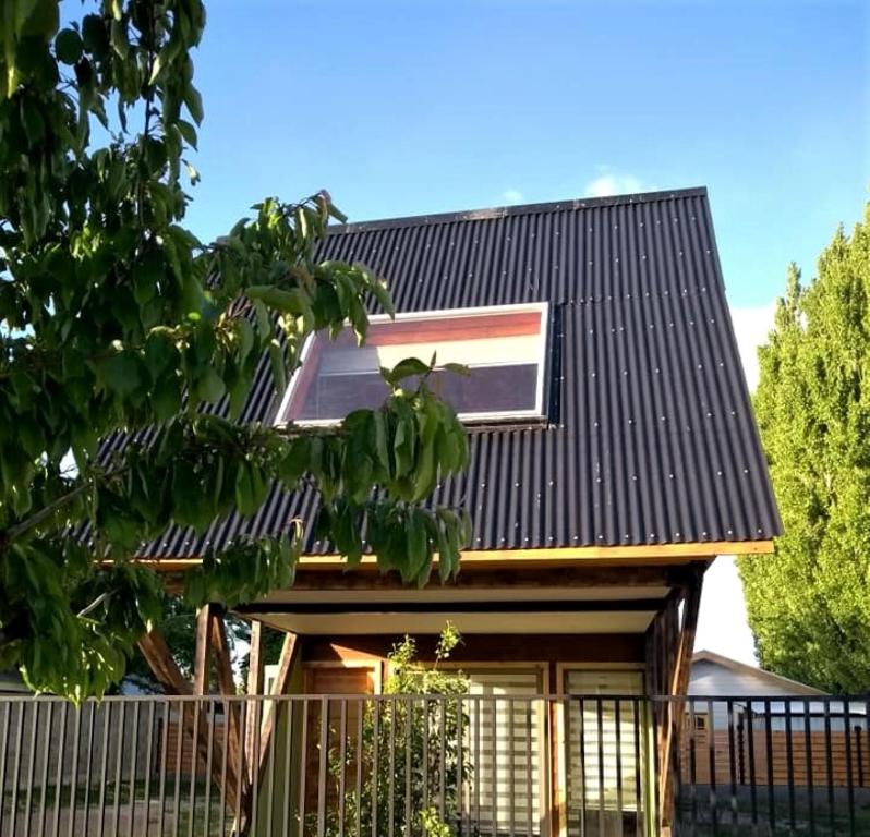a house with a black roof at EL RINCON DE LÚ in Chile Chico