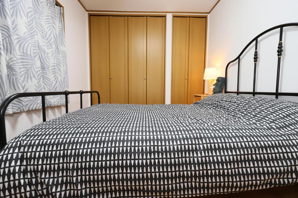Postel nebo postele na pokoji v ubytování Guest House Kubo Homes Matsu