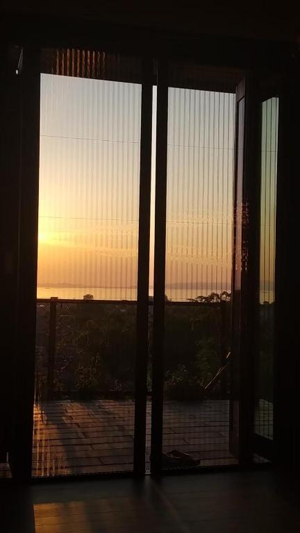 a view of the sunset from a room with a window at Bianca55 in Tannowa