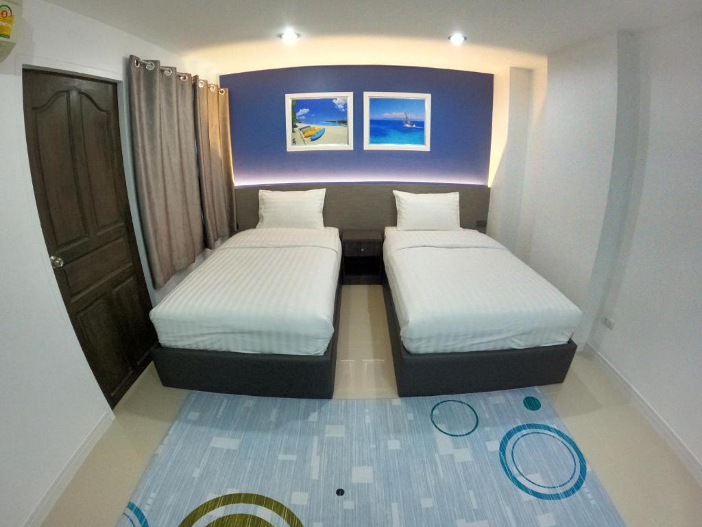 Postel nebo postele na pokoji v ubytování Poonsuk Place Hotel
