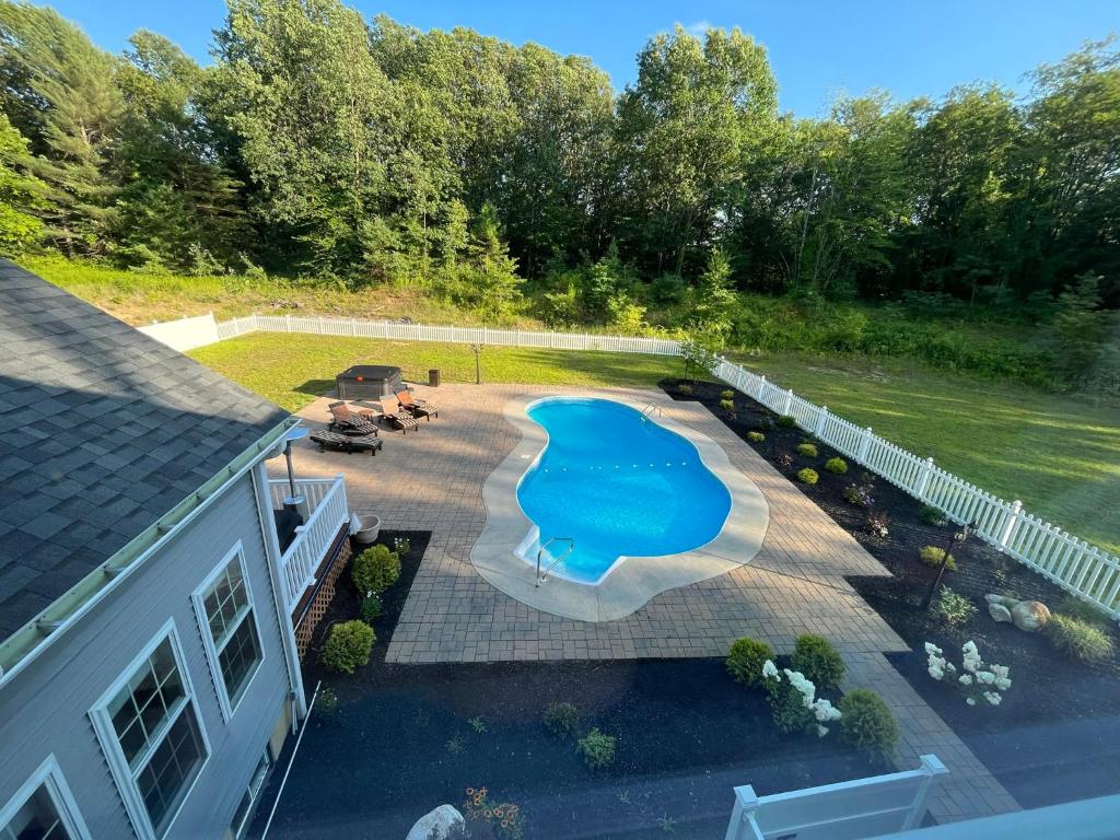 an overhead view of a backyard with a swimming pool at 9 Bedroom Saratoga Retreat, Heated Pool, HotTub, Firepit, Creek, Mini Golf On 10 Acres! in Saratoga Springs