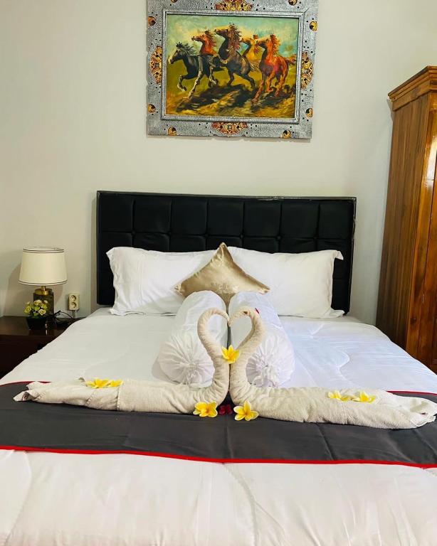 Postel nebo postele na pokoji v ubytování Guest House Pondok Puspa Ayu