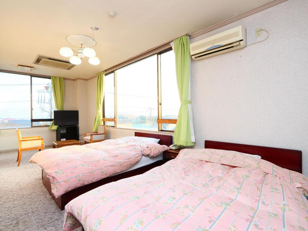 Postel nebo postele na pokoji v ubytování Seaside Hotel Kujukuri