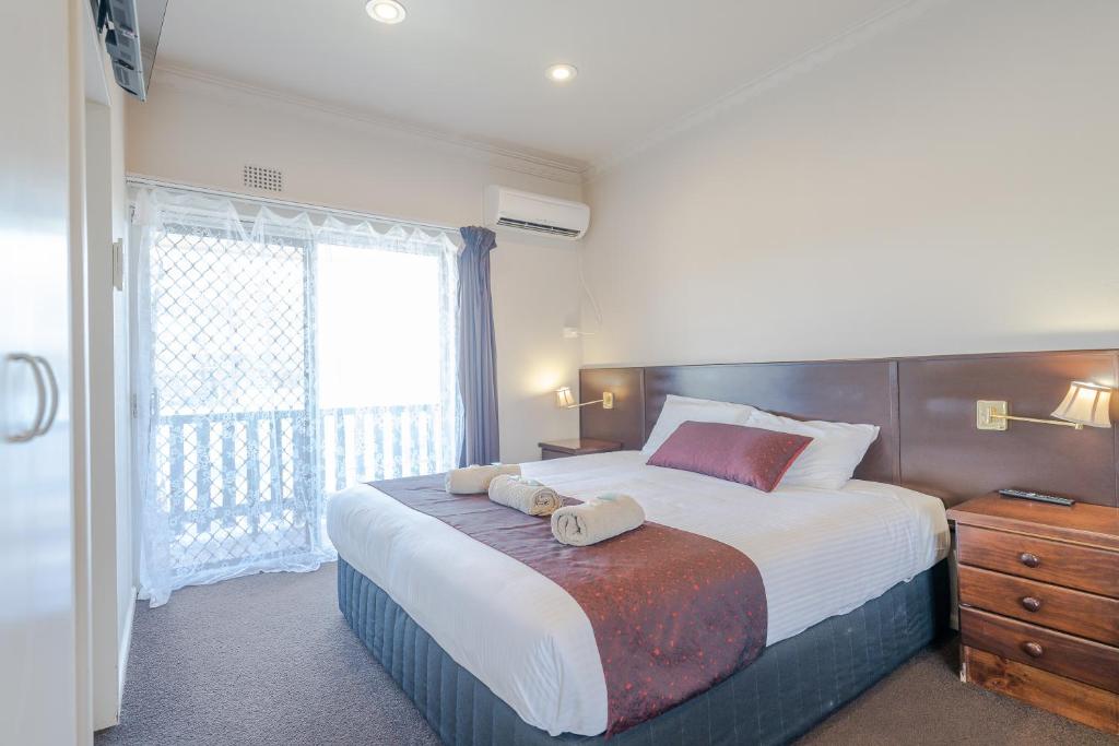 Un dormitorio con una cama grande y una ventana en Halfway Motel en Eden