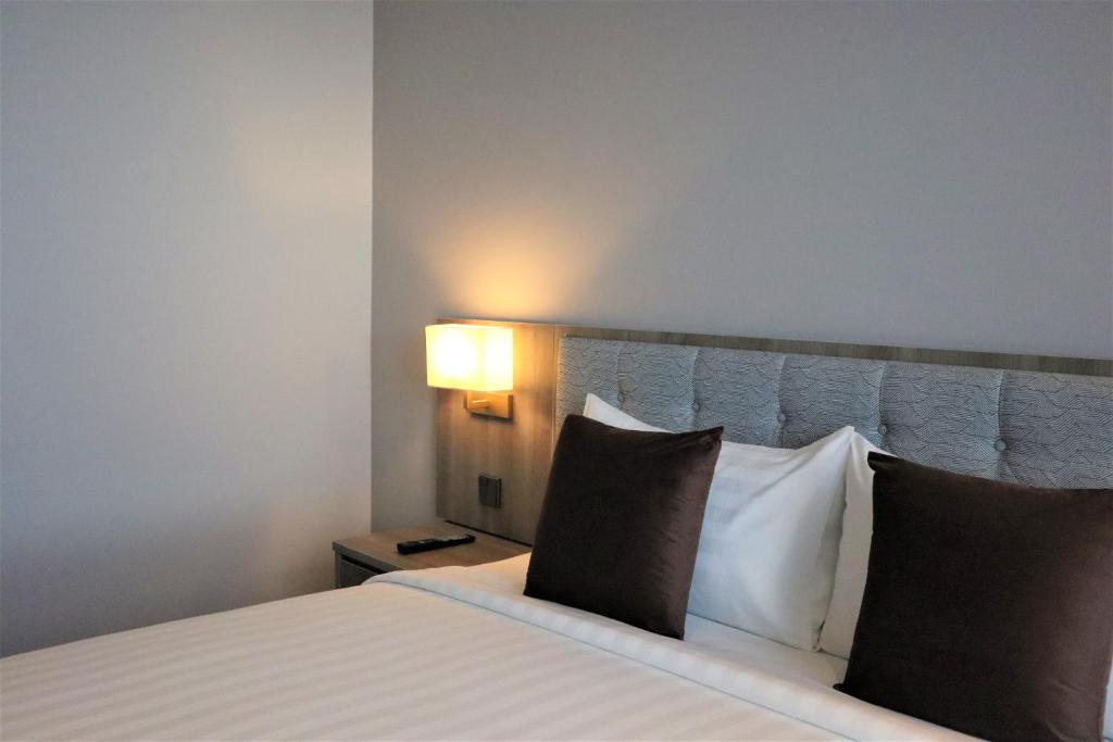 a hotel room with a bed with two pillows at KSL ESPLANADE HOTEL with HOT SPRING in Klang