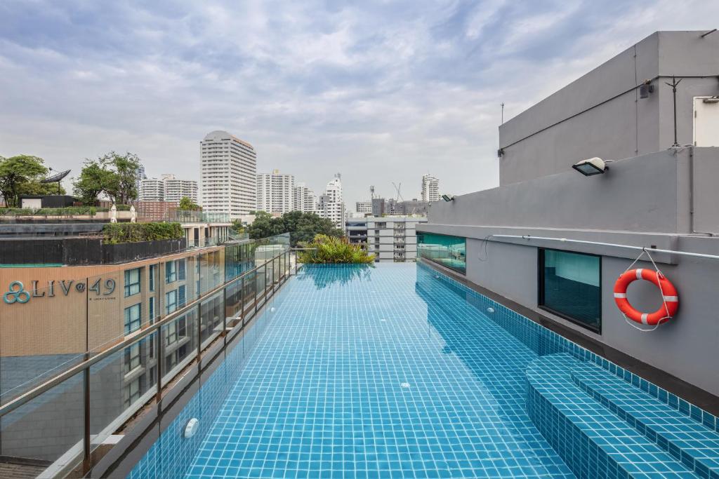 A rooftop swimming pool overlooking surrounding apartment towers.