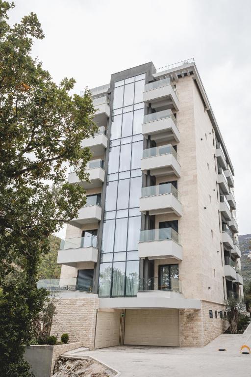 a building with glass windows on the side of it at Zafiro Residence in Budva