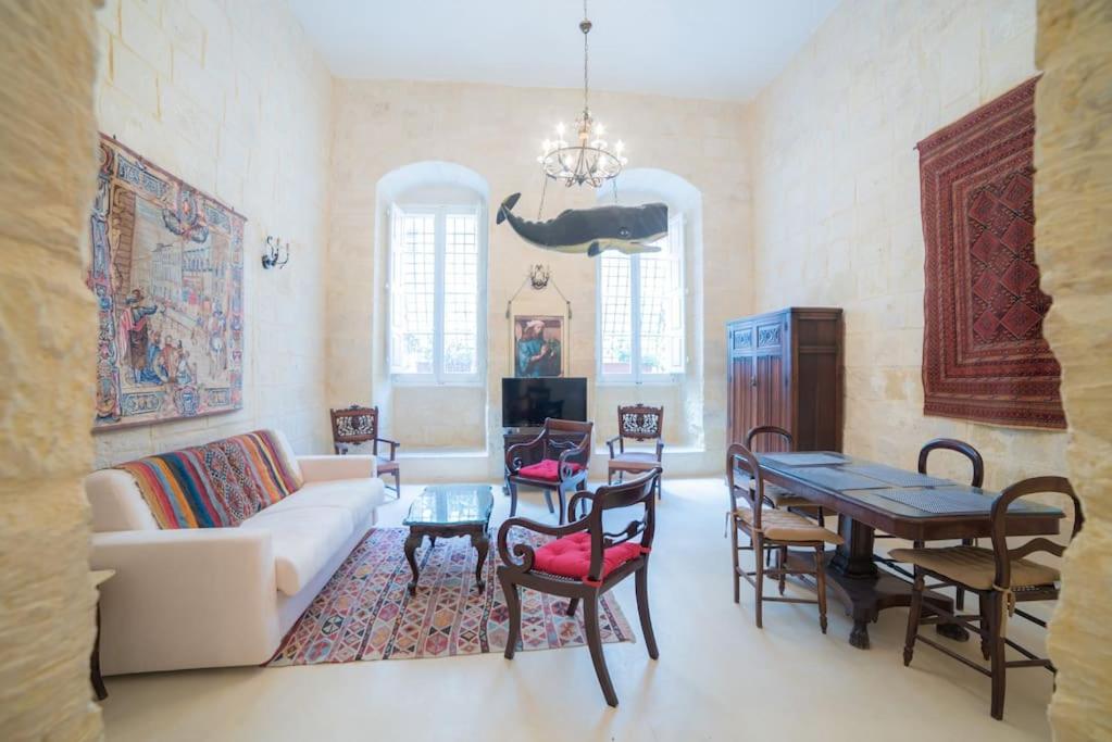 a living room with a couch and a table at HT1- Heritage Treasure 1 in Valletta