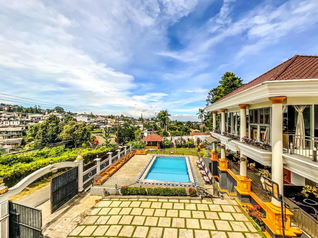 an image of a house with a swimming pool at Villa London Puncak in Sampal 2