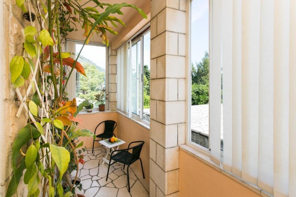 a balcony with two chairs and two windows at Yellow Room Guesthouse in Dubrovnik