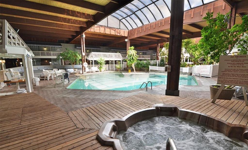 a pool with a hot tub in the middle of a building at Sturbridge Host Hotel And Conference Center in Sturbridge