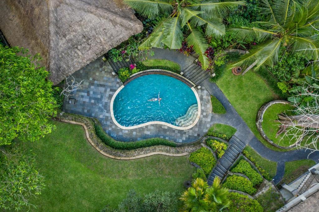 - une vue sur la piscine dans la cour dans l'établissement The Allure Ubud Villas, à Ubud