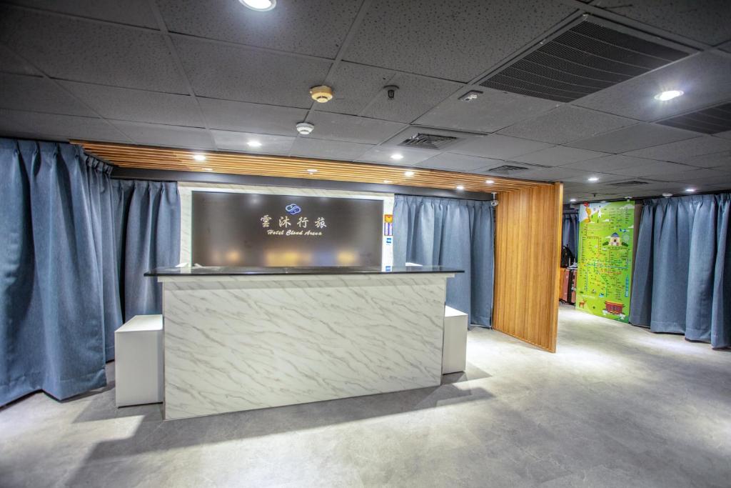 a lobby with blue curtains and a reception counter at 雲沐行旅 Hotel Cloud Arena-Daan in Taipei