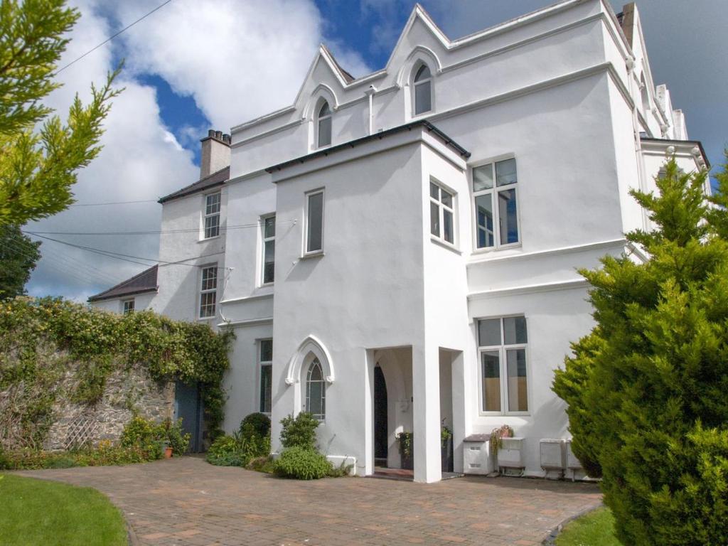 a large white house with a courtyard at Nevadd - Uk12303 in Menai Bridge