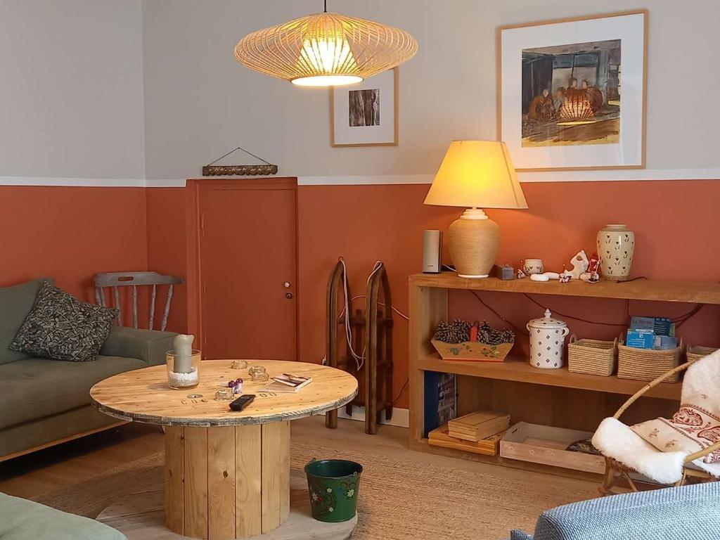 a living room with a table and a couch at Appartement Villard-de-Lans, 3 pièces, 5 personnes - FR-1-548-19 in Villard-de-Lans