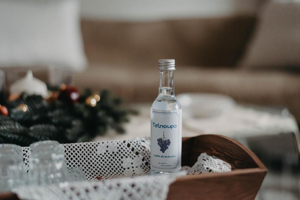a bottle of water on a table with a christmas tree at DimSim Home-Σπίτι με όνομα in Tríkala